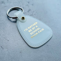 I’d Rather be at a School Book Fair Saddle Keychain
